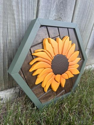 Hand cut sunflower on a hexagon shaped herringbone backrground