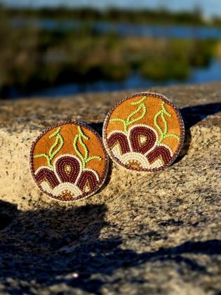 Inspired by the resilience of the northern landscape, these earrings celebrate the quiet return of life with each changing season. Like new growth emerging from the earth after a long winter, they honour the strength, renewal, and beauty found throughout the North. Through every bead and stitch, this piece reflects the enduring relationship between people, the land, and the stories that continue to grow across generations.