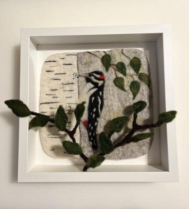 Needle felted woodpecker on a wet felted background 