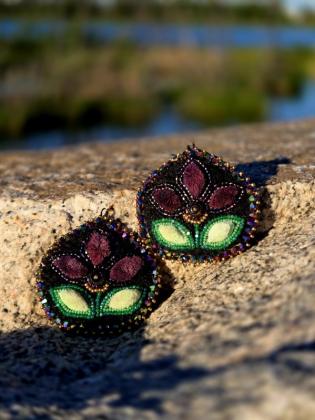 Inspired by the Northern Lights that illuminate the skies of the Northwest Territories, this piece celebrates one of the North's most breathtaking gifts. Flowing shades of green and purple reflect the movement of the aurora as it dances across the night sky, creating moments of wonder that connect us to the land, the seasons, and those who have gathered beneath its light for generations. Through every bead and stitch, this piece honors the beauty, mystery, and enduring spirit of the North.