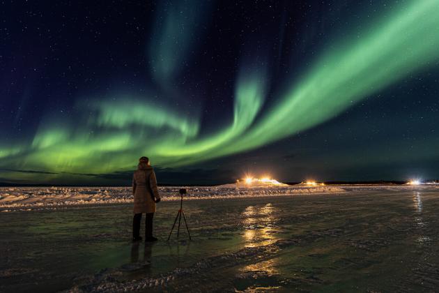 Mackenzie River Ice Road and Oilfield Islands lit up by Northern Lights in Norman Wells