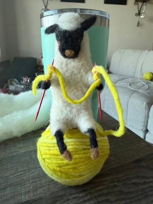 needle felted sheep sitting on ball of wool