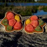 Inspired by the vibrant colours that blanket the northern tundra each summer, these earrings celebrate the beauty that flourishes in a landscape shaped by resilience. Created using traditional caribou hair tufting on hand-tanned and smoked moosehide, they honour the knowledge, artistry, and respect for the land that have been carried forward through generations. Through every stitch and tuft, this piece reflects the enduring relationship between people, culture, and the North.